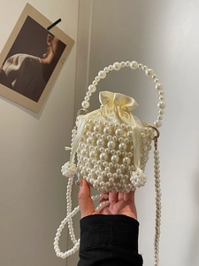 Elegant ivory pearl woven bucket bag with satin drawstring liner and shoulder strap