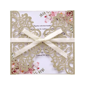 Laser cut champagne glitter wedding invitation with elegant satin bow and floral insert card