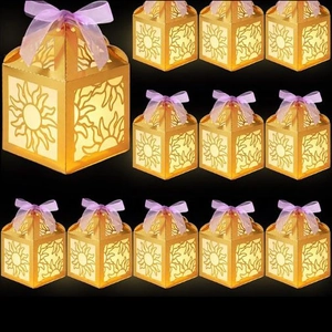 Set of 12 gold laser-cut favor boxes with sun pattern and elegant purple ribbons