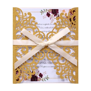 Laser cut hollow wedding invitation with gold glitter cover and elegant white ribbon bow
