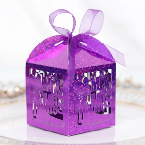Detail view of purple glitter wedding favor box with laser-cut MR & MRS and ribbon