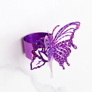 Macro shot of 3D purple glitter butterfly napkin ring with laser-cut hollow design