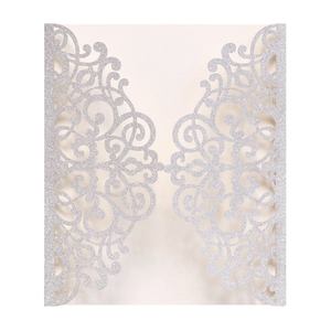 Close-up of laser cut silver glitter invitation card with elegant floral hollow patterns