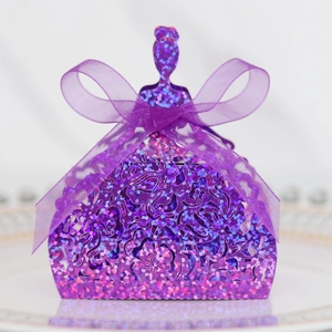 Macro detail of purple glitter favor box in princess dress shape with laser-cut patterns