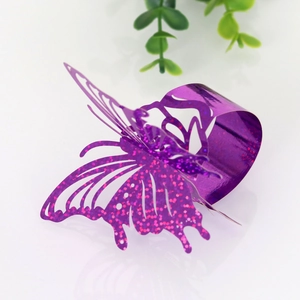 Macro detail of laser-cut purple butterfly napkin ring with sparkling pink glitter