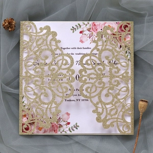 Detailed laser-cut gold glitter wedding invitation with elegant pink floral inner card