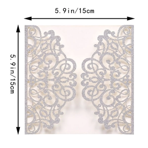 Detail of silver glitter laser cut wedding invitation cover with floral pattern
