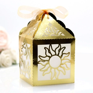 Elegant gold laser-cut sunburst gift box with a silk ribbon bow for festive parties