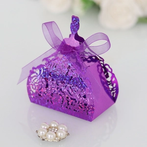 Close-up of purple laser-cut wedding favor box with glitter finish and silk ribbon bow