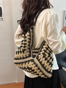 Bohemian woven tote bag in black and cream featuring geometric knit patterns and leather straps