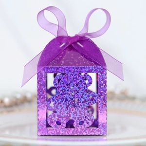 Detail of purple glitter candy box with hollow bear pattern and matching ribbon bow