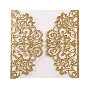 Close-up of laser-cut gold glitter invitation cover with intricate mandala patterns