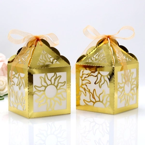 Golden laser-cut sunflower gift boxes with elegant ribbon bows on a reflective surface