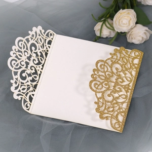 Detail of laser-cut glitter wedding invitation with European floral patterns and rose decor