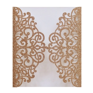 Macro detail of rose gold laser-cut floral invitation with metallic glitter finish