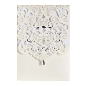 Detail of laser-cut lace invitation with heart pattern, cream sleeve and teardrop rhinestone
