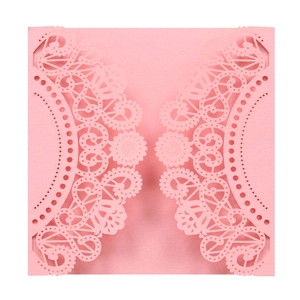 Close-up of pink laser-cut lace floral pattern on a formal invitation card sleeve