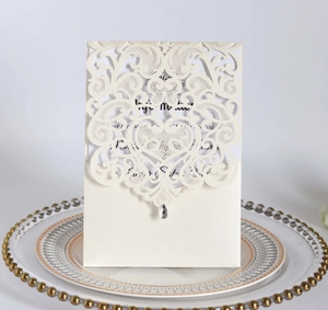 Detailed laser-cut heart lace wedding invitation in cream beige with sparkling teardrop crystal