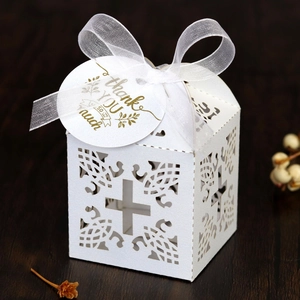 Detailed laser-cut white wedding favor box with cross design and Thank You tag