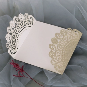 Detailed laser-cut lace wedding invitation cover with gold glitter edge and red flower