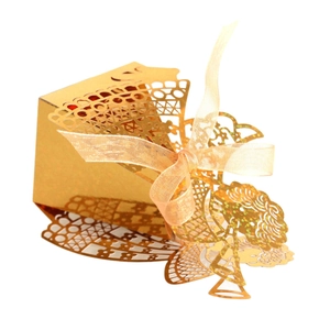 Elegant gold laser-cut gift box for candies with a ribbon bow on a white background