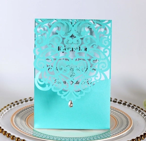 Detail of laser-cut heart pattern wedding invitation with Tiffany blue sleeve and rhinestone