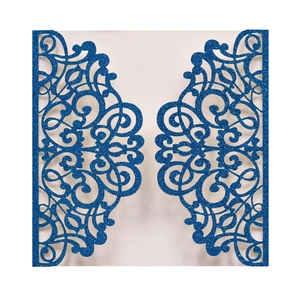 Detail of laser-cut glitter blue wedding invitation sleeve with European floral pattern