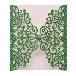 Laser cut invitation card in green glitter paper with symmetrical floral lace pattern