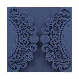 Detailed laser-cut lace pattern on navy blue pearlescent cardstock wedding invitation cover