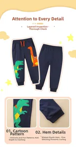Detailed view of cartoon dinosaur embroidery and ribbed elastic cuffs on navy boys joggers