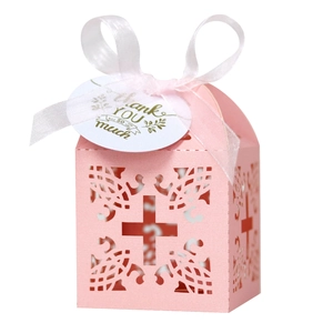 Pink laser cut wedding favor box with cross design, white ribbon and thank you tag