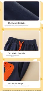 Detail view of boys navy blue jogger pants featuring orange dinosaur print and drawstring