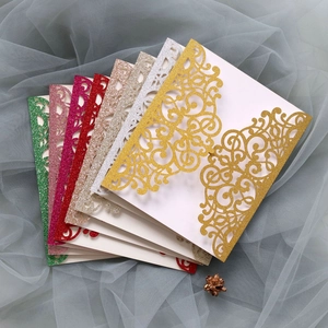 Detailed fan-shaped layout of laser cut glitter invitation cards in various colors