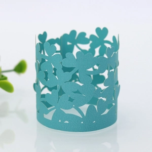 Detailed laser-cut heart and clover pattern on teal pearlescent paper napkin ring