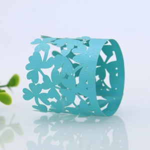 Macro view of light blue four-leaf clover laser-cut napkin ring with pearlescent finish