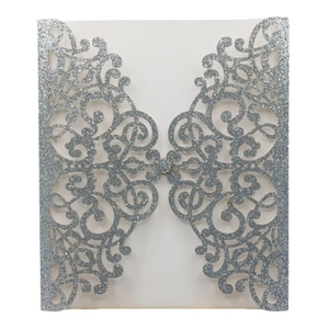 Detailed silver glitter laser cut invitation cover with elegant European scroll patterns