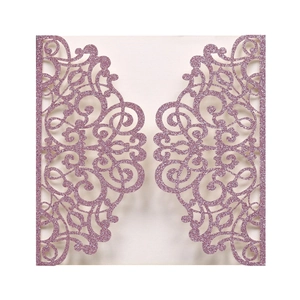 Macro detail of laser cut wedding invitation cover with pink glitter and floral pattern