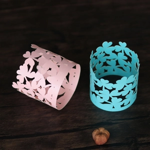 Macro detail of laser-cut clover pattern pearl paper napkin ring for party decor