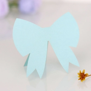 Detail of light blue glitter 3D bow place card for weddings and party table settings