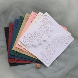 Detailed laser-cut lace wedding invitation covers in multiple elegant colors and textures