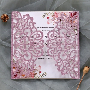 Detail of pink glitter laser cut wedding invitation with floral insert and intricate pattern