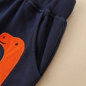 Boys navy joggers featuring elastic waist and orange cartoon dinosaur embroidery detail