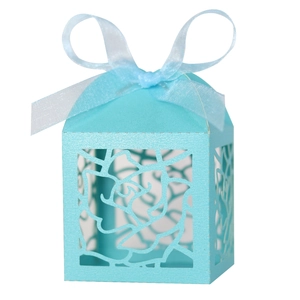 Detailed laser-cut rose hollow favor box in light blue with matching silk ribbon