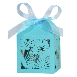 Detail of light blue laser-cut candy box with hollow leaf pattern and ribbon bow