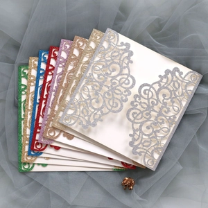 Detail of glitter laser cut wedding invitation covers in multiple colors and patterns