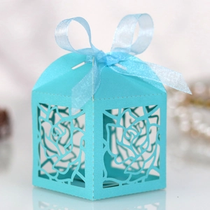 Close-up of laser-cut rose hollow favor box in light blue with elegant ribbon bow