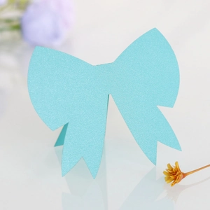 Detail of teal 3D bow place card with shimmering pearlescent finish for wedding table decor