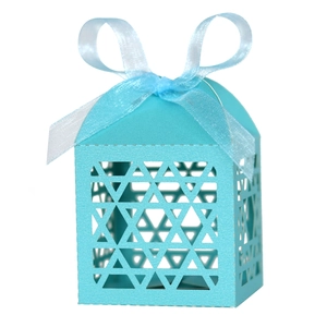 Detail of laser-cut geometric patterns on a Tiffany blue favor box with blue ribbon bow