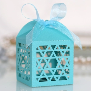 Detailed laser-cut Star of David patterns on light blue gift box with ribbon