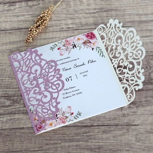 Detailed laser-cut wedding invitation with purple glitter and elegant floral inner card